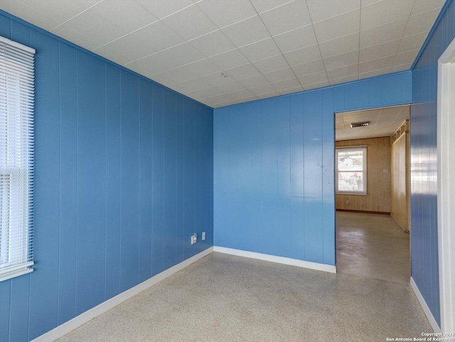 spare room featuring visible vents and baseboards