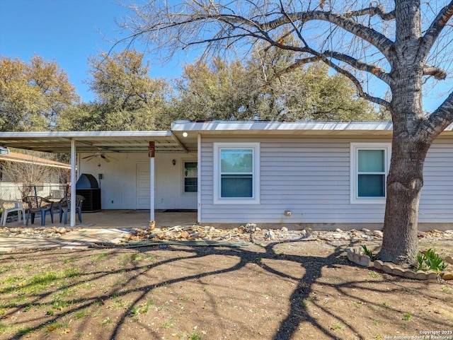 rear view of house featuring a carport