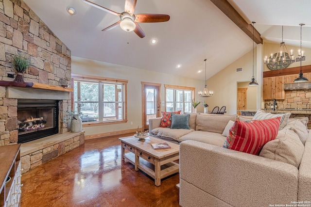 living room with visible vents, baseboards, concrete floors, a stone fireplace, and ceiling fan with notable chandelier