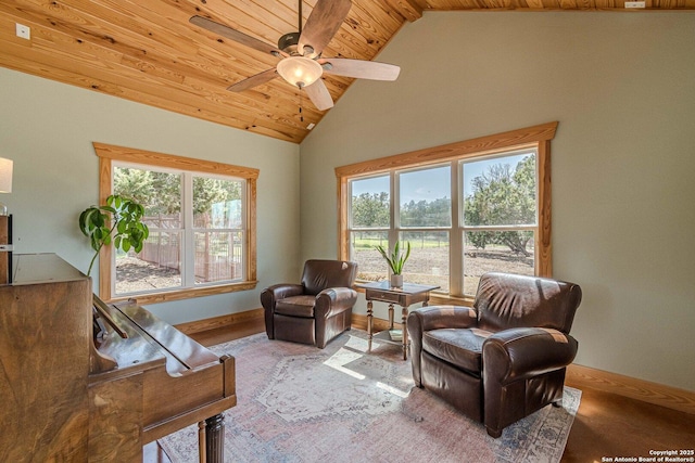 sitting room featuring high vaulted ceiling, wooden ceiling, baseboards, and a ceiling fan