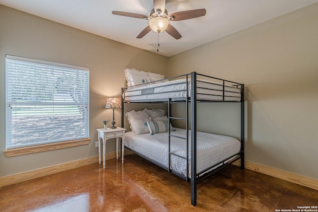 bedroom featuring baseboards, concrete floors, and ceiling fan