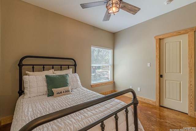 bedroom with finished concrete floors, ceiling fan, and baseboards