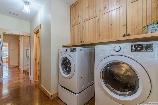 laundry area with washer and dryer, dark wood-type flooring, baseboards, and visible vents