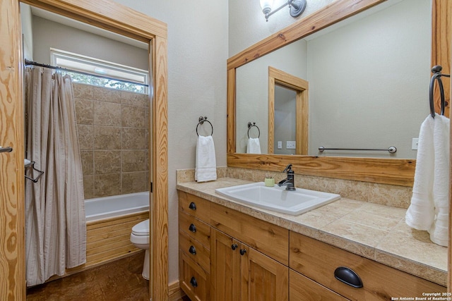 full bath featuring vanity, toilet, and shower / bath combo