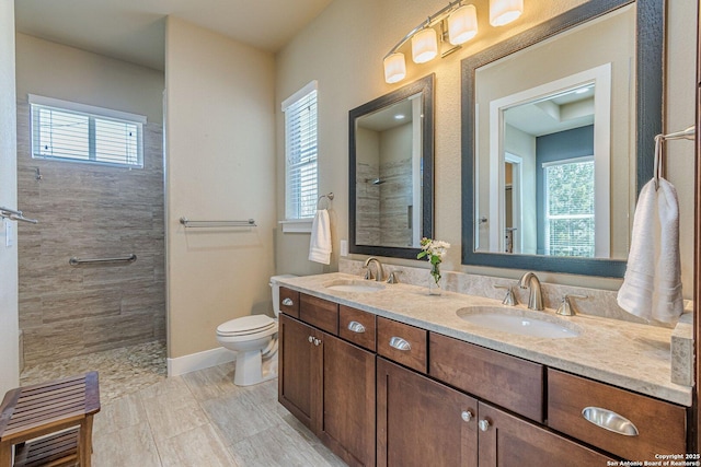 full bathroom with toilet, plenty of natural light, and a sink