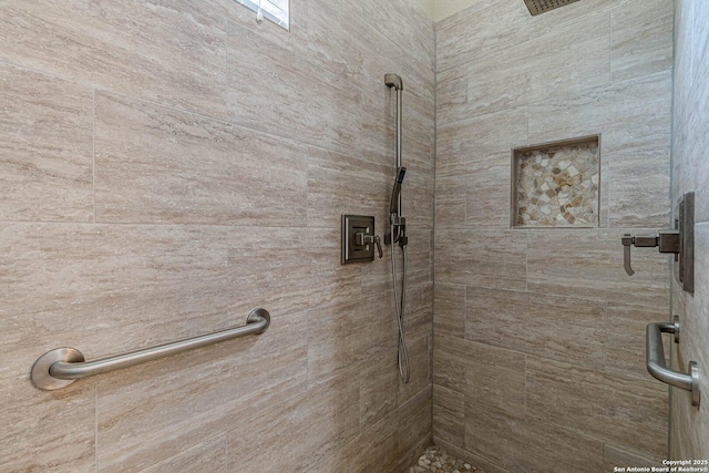 bathroom with tiled shower