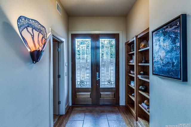 entryway with wood finished floors and visible vents