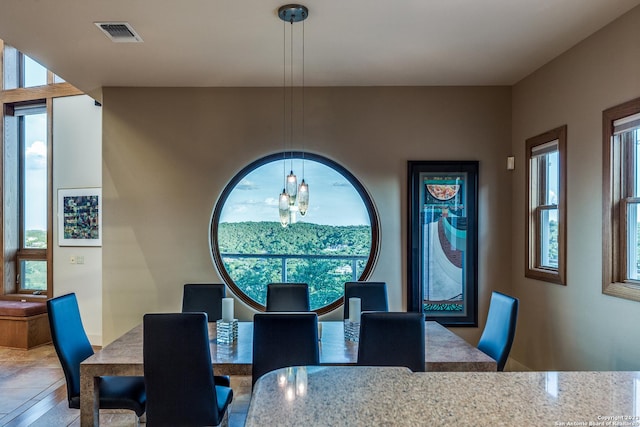 dining space featuring a chandelier and visible vents