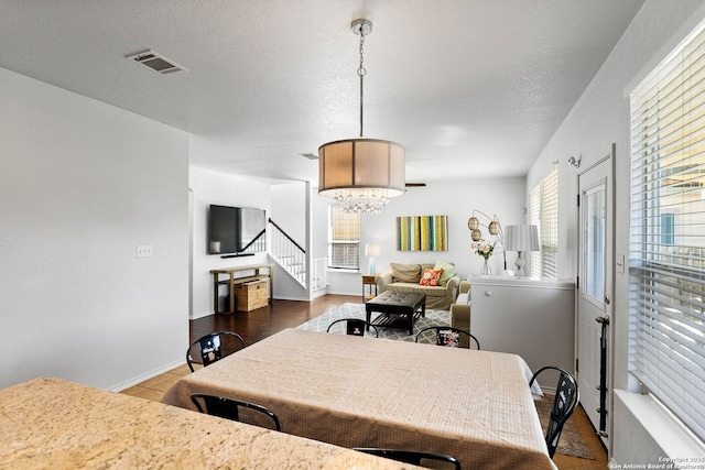 kitchen with visible vents, a textured ceiling, and baseboards