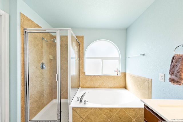 bathroom with vanity, a bath, and a stall shower