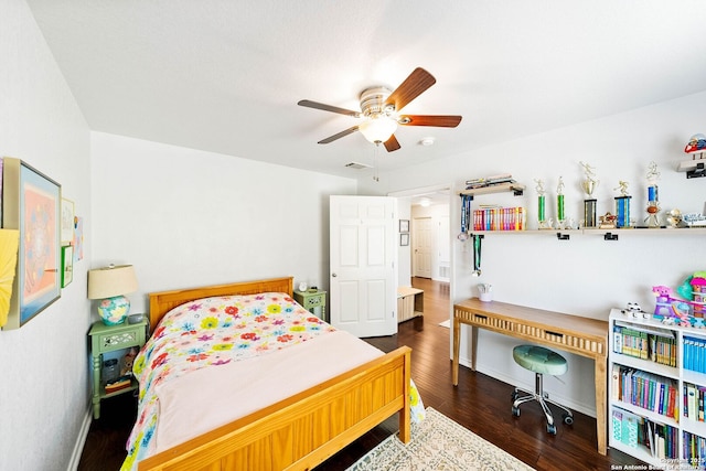 bedroom featuring ceiling fan, visible vents, and wood finished floors