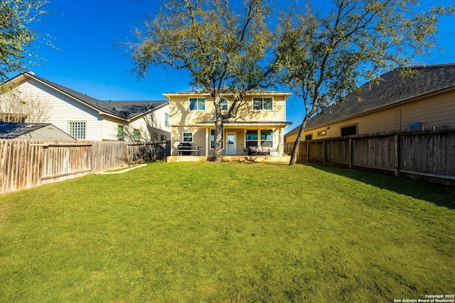 rear view of property with a patio area, a lawn, and a fenced backyard