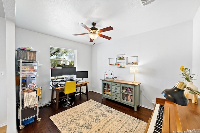 office space with a ceiling fan, visible vents, baseboards, hardwood / wood-style flooring, and a textured ceiling