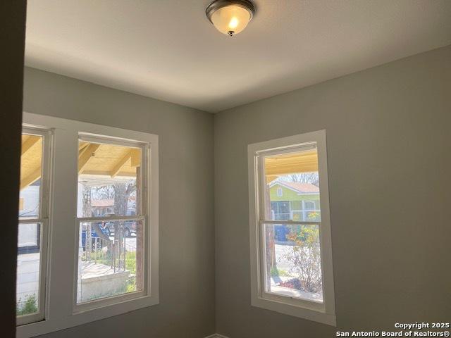 unfurnished room featuring a wealth of natural light