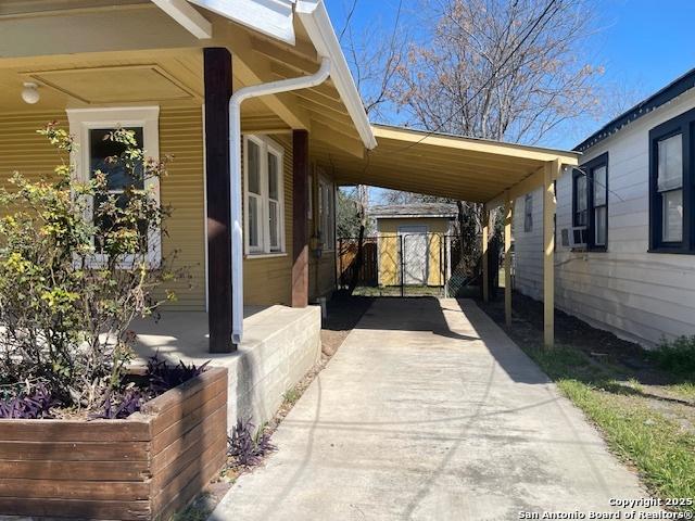 view of patio with a carport and driveway