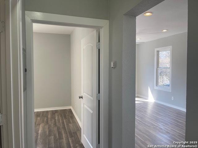 corridor featuring recessed lighting, baseboards, and wood finished floors