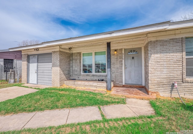 property entrance featuring brick siding