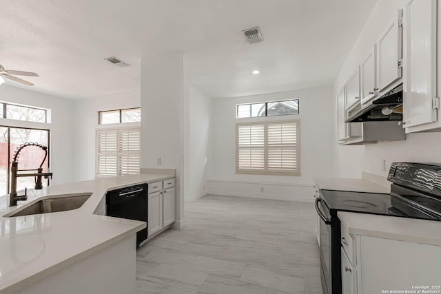 kitchen featuring visible vents, black appliances, a ceiling fan, a sink, and under cabinet range hood