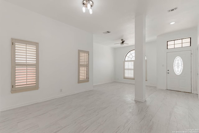 entryway featuring visible vents, marble finish floor, baseboards, and a ceiling fan