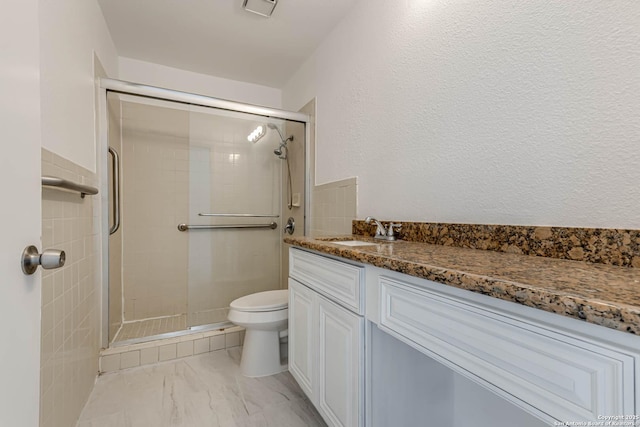 full bath with visible vents, toilet, marble finish floor, a shower stall, and vanity