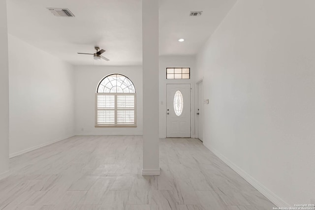 foyer entrance with visible vents, baseboards, and ceiling fan