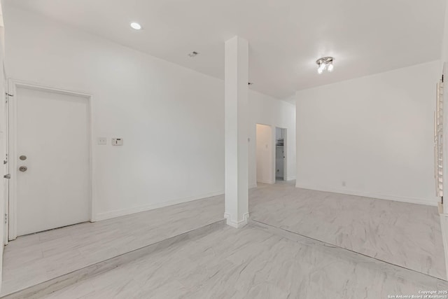 unfurnished room featuring baseboards