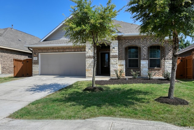 view of front of house with concrete driveway, fence, a garage, and roof with shingles