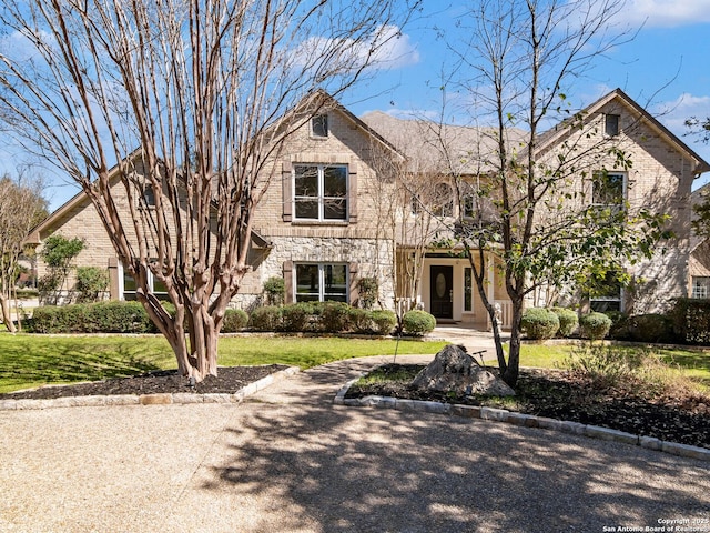 view of front of property with stone siding and a front yard