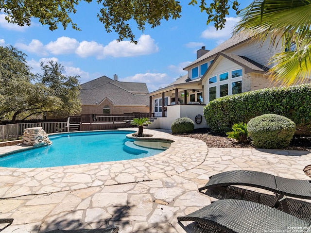 view of pool with a fenced in pool, a patio area, and fence