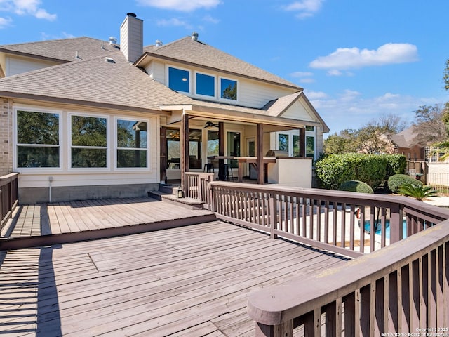 deck featuring a fenced in pool