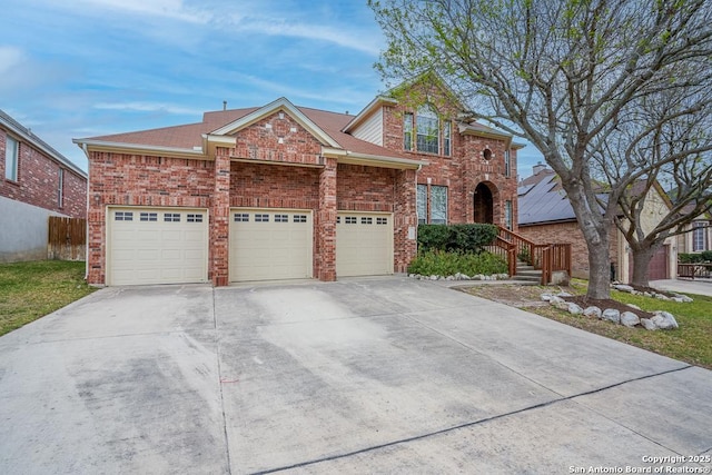 view of front of home featuring a garage, brick siding, and driveway