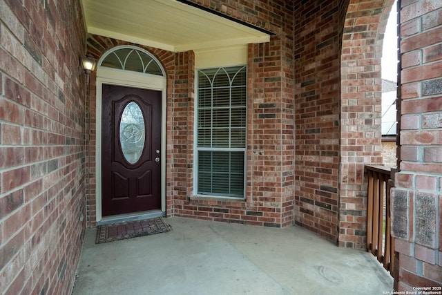 doorway to property with brick siding