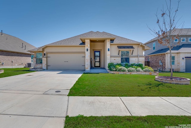 prairie-style house with concrete driveway, a front yard, stucco siding, a garage, and stone siding