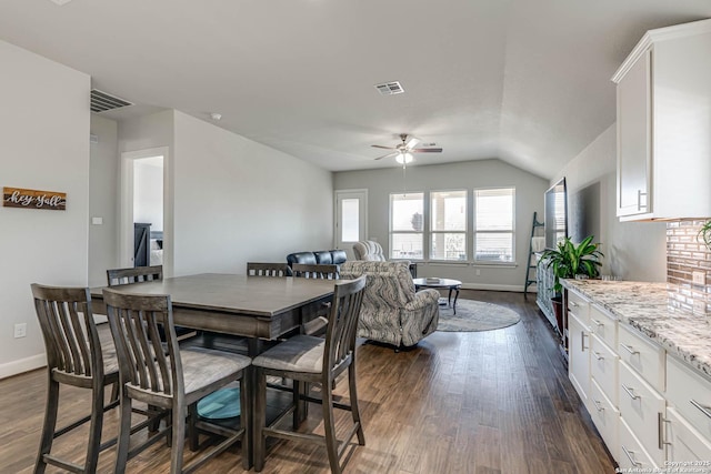 dining space with visible vents, baseboards, ceiling fan, and dark wood-style flooring