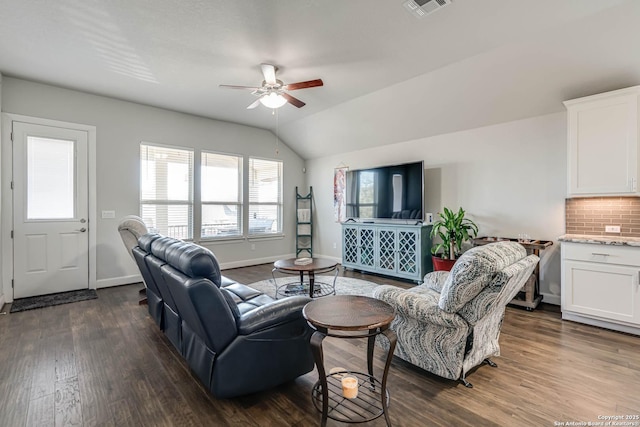 living room featuring a ceiling fan, visible vents, baseboards, lofted ceiling, and dark wood-style flooring