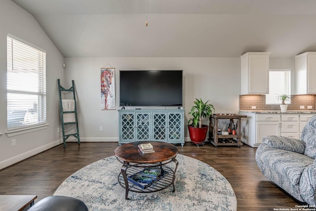 living room featuring baseboards, lofted ceiling, and dark wood-style flooring