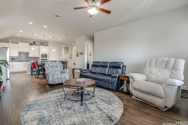 living area with visible vents, recessed lighting, dark wood-style flooring, ceiling fan, and vaulted ceiling