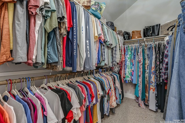 spacious closet featuring lofted ceiling and carpet floors