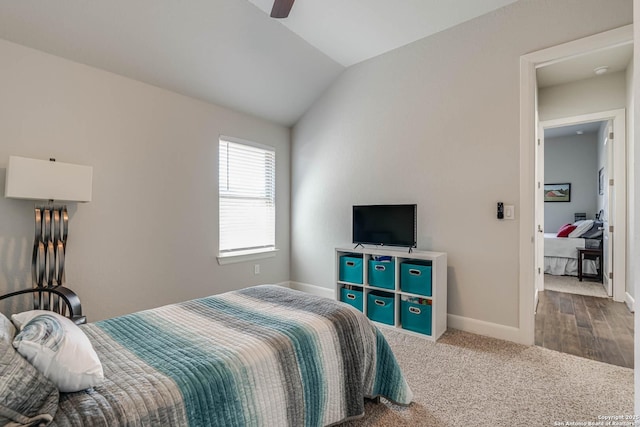 carpeted bedroom featuring baseboards, a ceiling fan, and vaulted ceiling