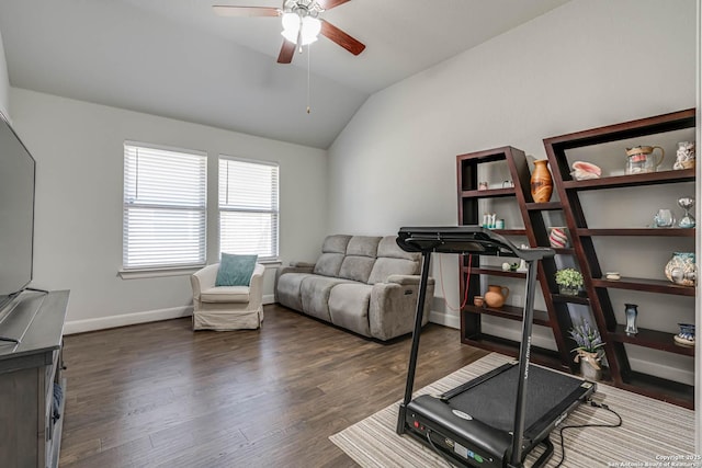 exercise area featuring vaulted ceiling, baseboards, dark wood-type flooring, and ceiling fan