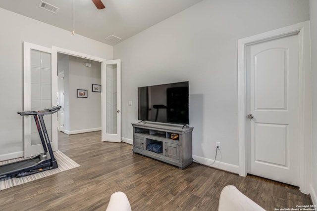 living room with vaulted ceiling, visible vents, a ceiling fan, and wood finished floors