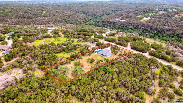 drone / aerial view featuring a view of trees