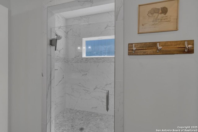 bathroom with a marble finish shower