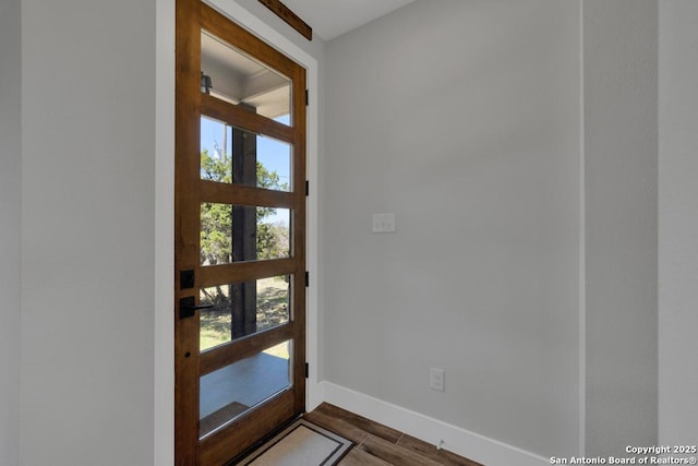 entryway featuring dark wood finished floors and baseboards