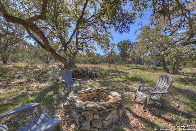 view of yard with an outdoor fire pit