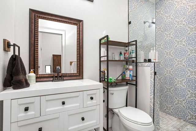 full bath featuring vanity, toilet, and a shower