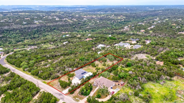 birds eye view of property with a wooded view