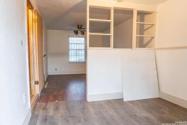 unfurnished room with wood finished floors, baseboards, and ceiling fan