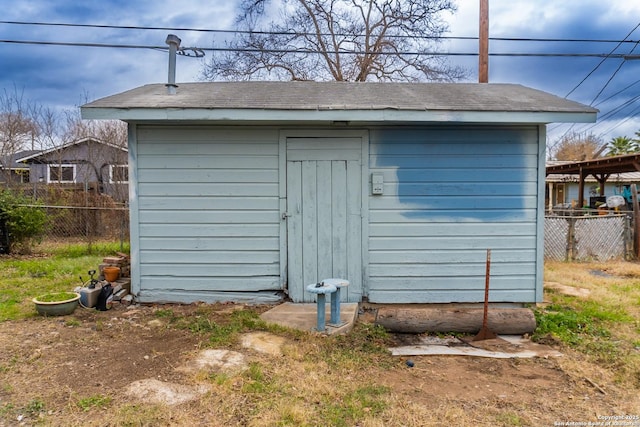 view of shed featuring fence