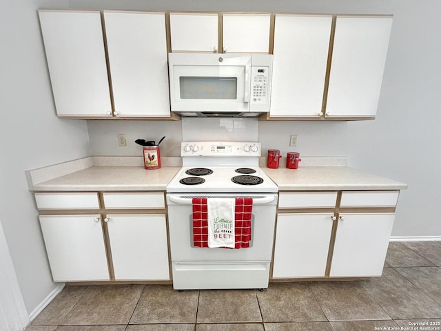 kitchen featuring white appliances, baseboards, light tile patterned flooring, light countertops, and white cabinetry